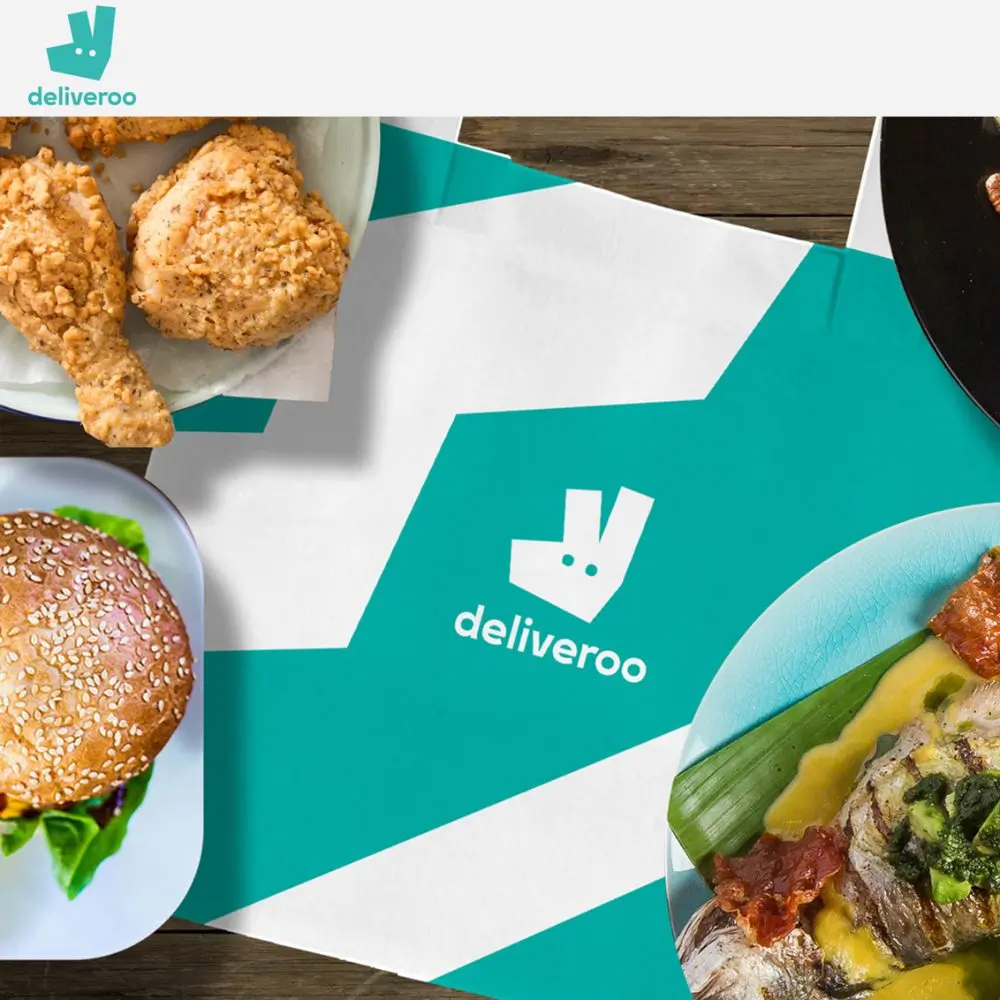 Deliveroo bag surrounded by takeout meals.