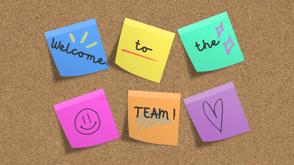 Colourful sticky notes saying "Welcome to the team" on a pin board to represent company onboarding